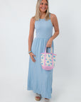 Light blue sleeveless midi dress with a gathered waist, worn with sunglasses and a beach tote, perfect for summer and casual wear