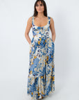 Model wearing boho floral maxi dress with pockets and flowy skirt