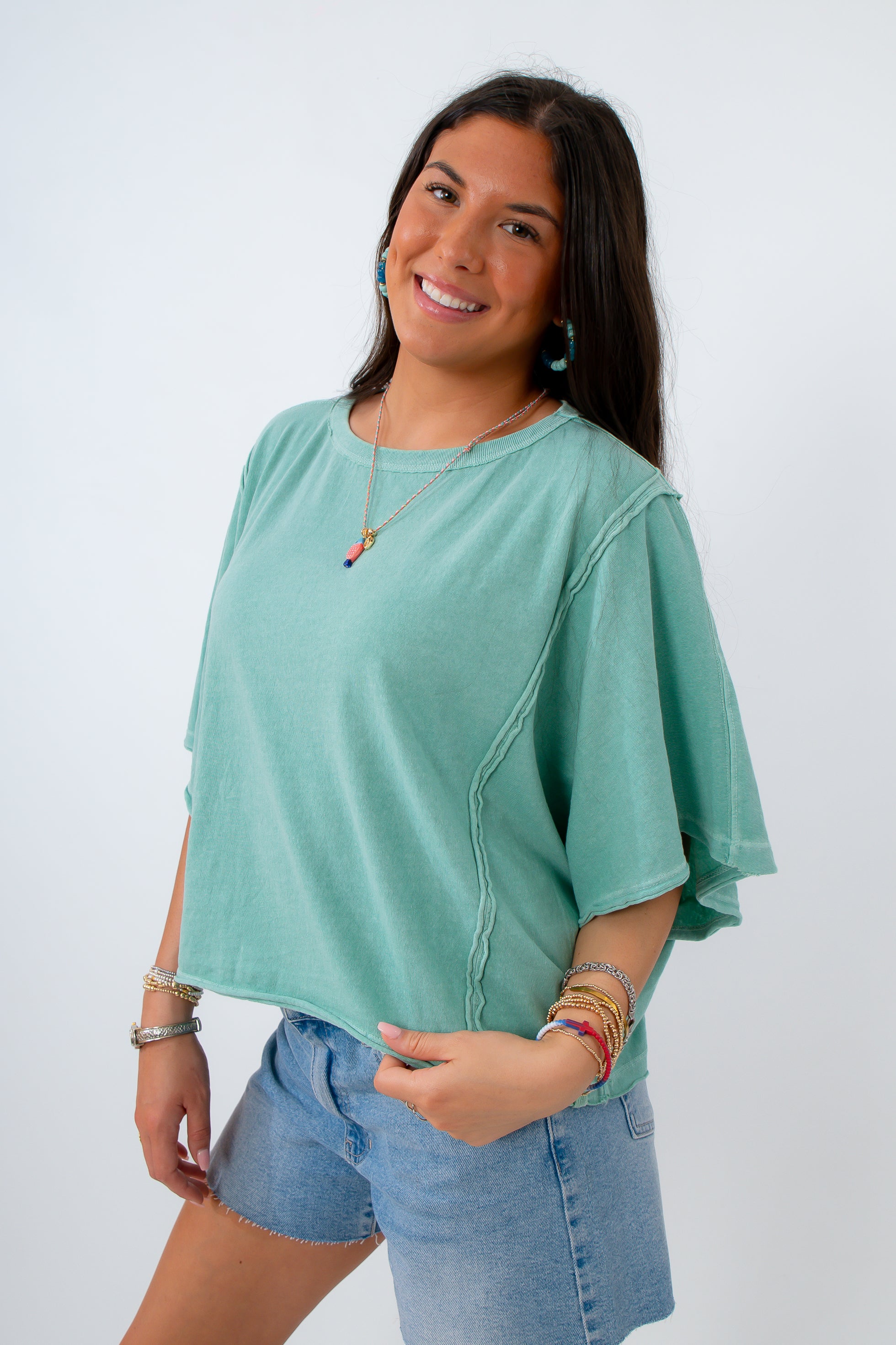 oversized teal t shirt for summer with fish necklace and bracelet stack