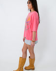 Side view of pink graphic T-shirt with relaxed fit and short sleeves