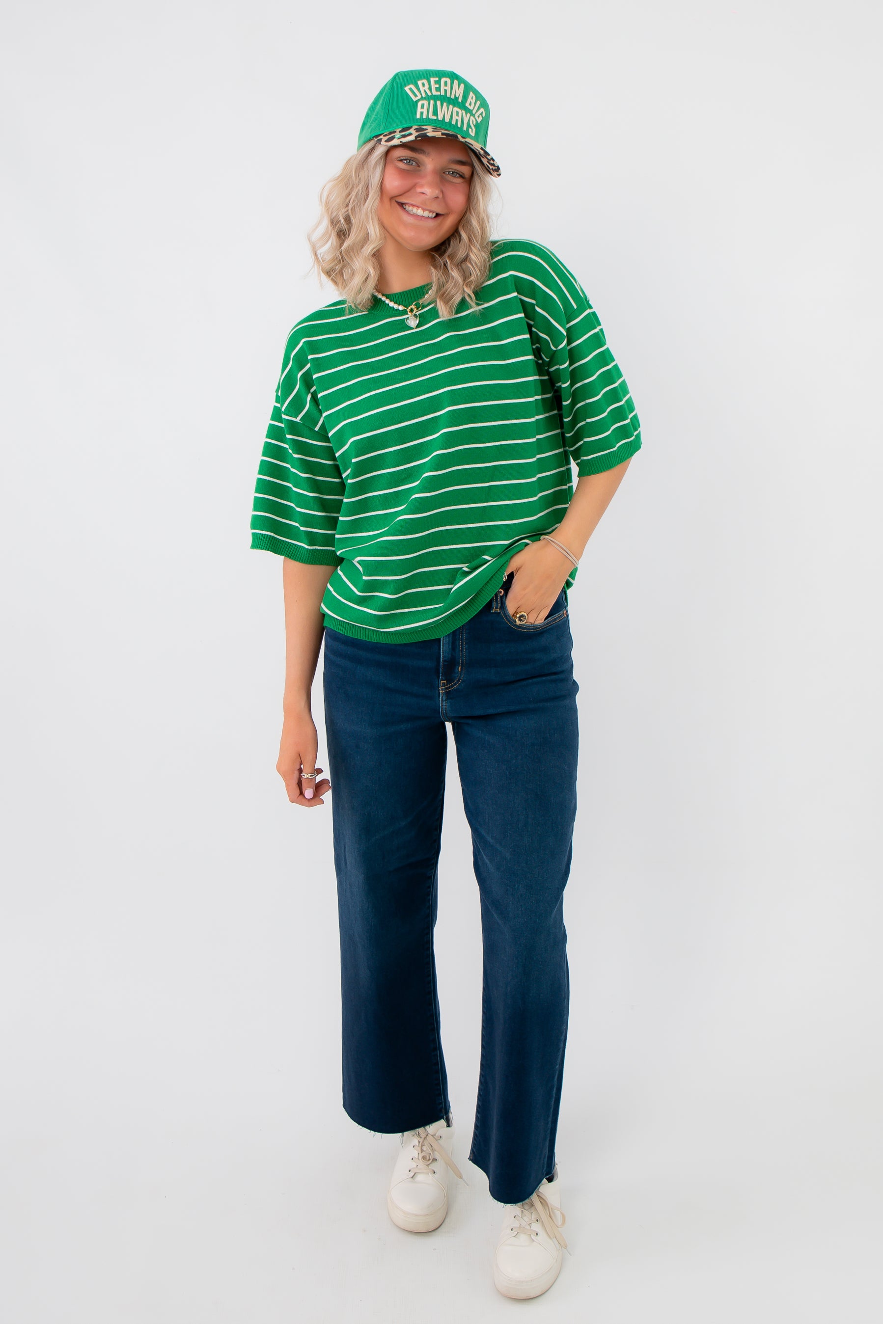 Gwen Green Striped Top – Casual boxy fit short sleeve green top with white stripes, styled with denim jeans and sneakers for everyday wear.