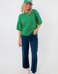 Gwen Green Striped Top – Casual boxy fit short sleeve green top with white stripes, styled with denim jeans and sneakers for everyday wear.