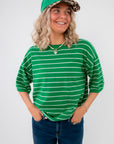Gwen Green Striped Top – Stylish green short sleeve top with drop shoulders and white stripes, perfect for layering or casual outfits.