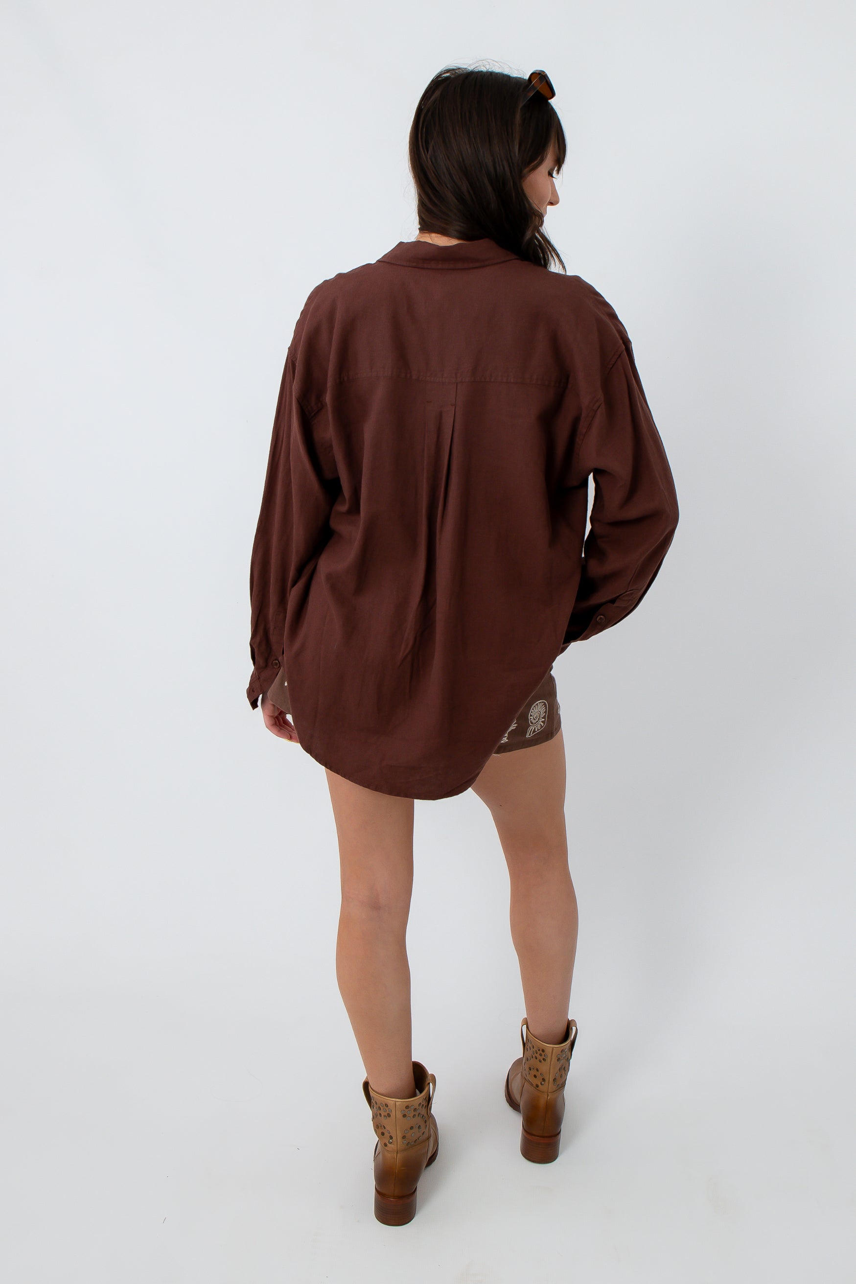 Women’s oversized brown button-up shirt with long sleeves, back view