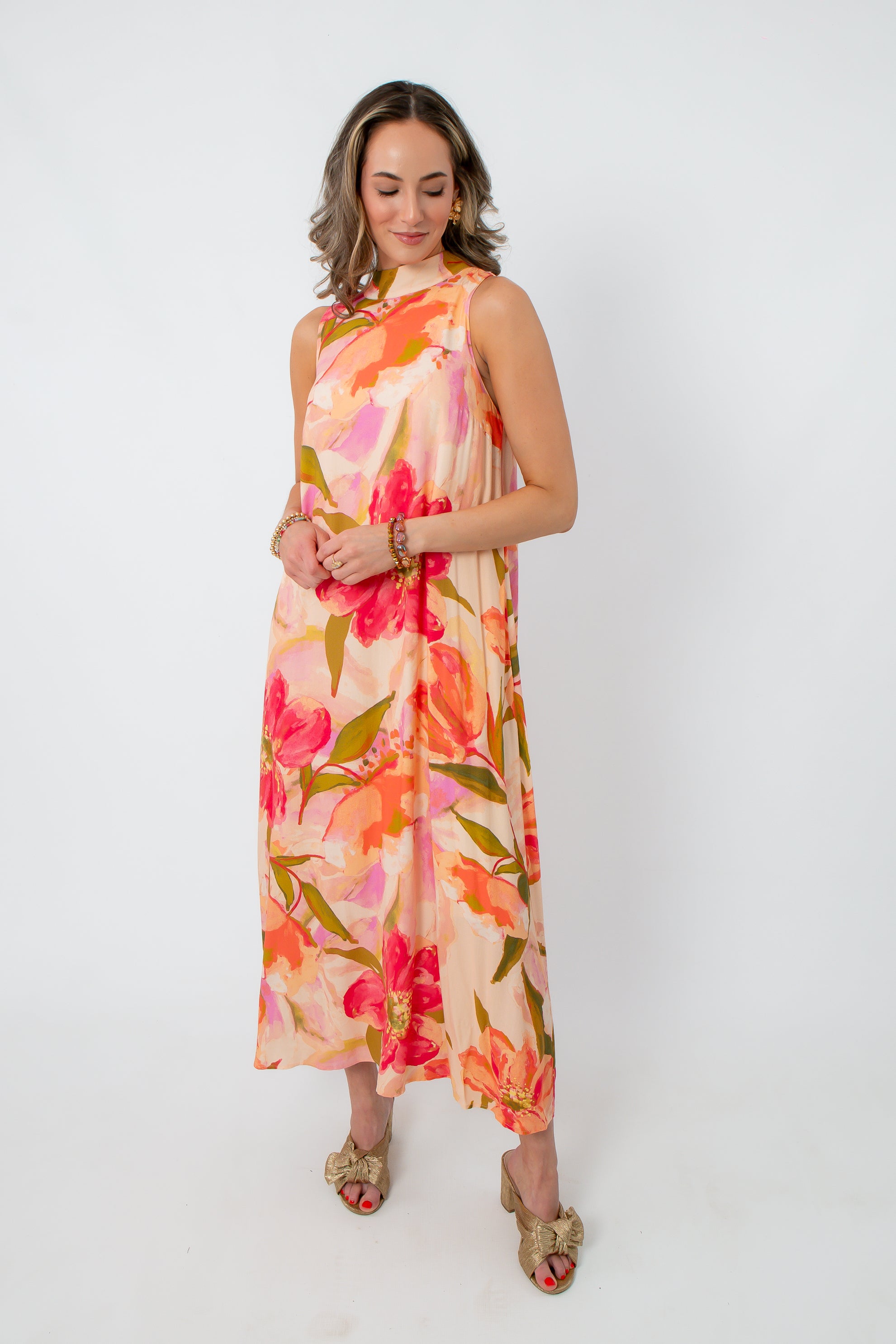 Vibrant floral maxi dress with pink, orange, and green print, sleeveless, elegant for wedding guests