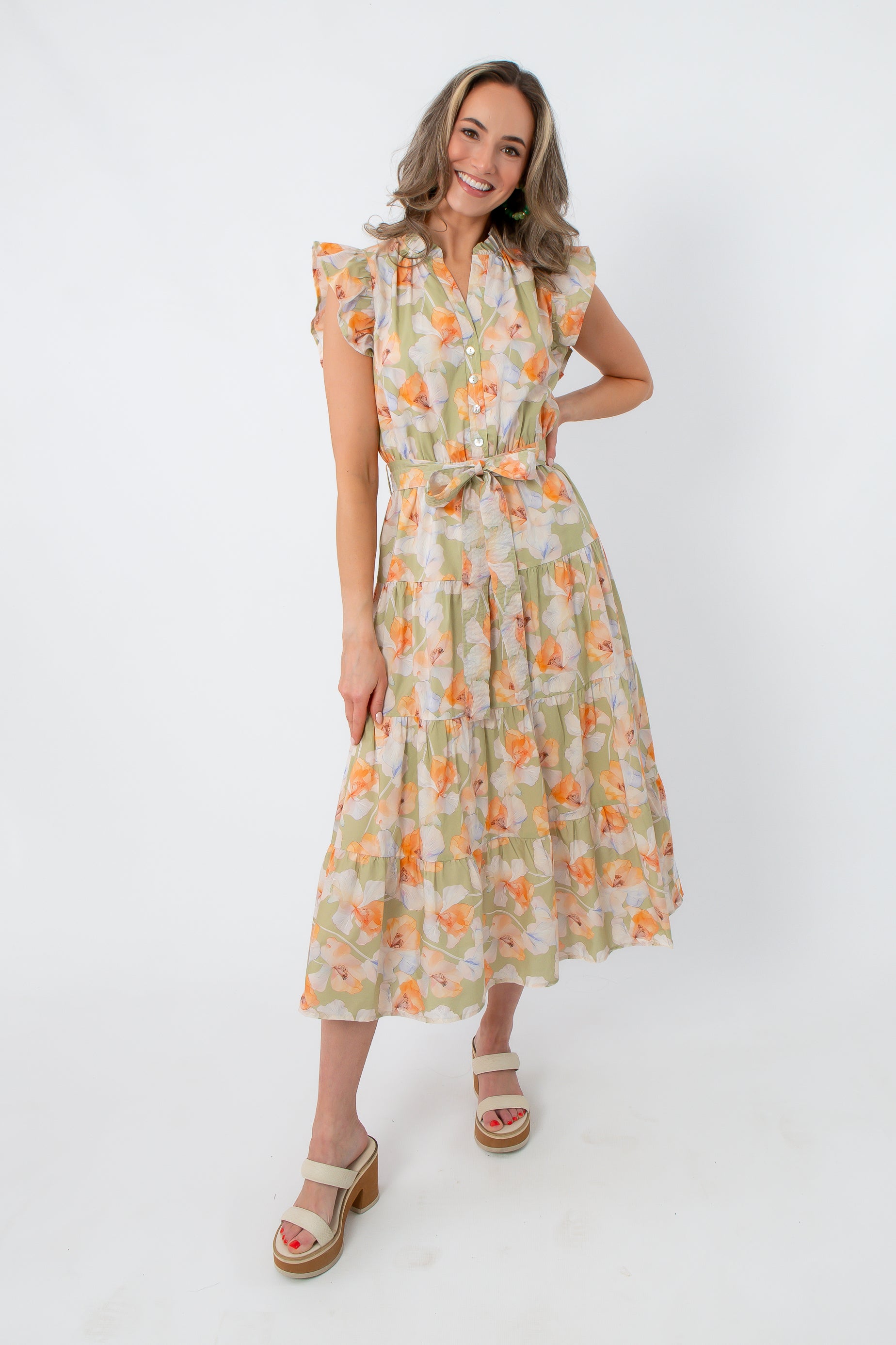 Side view of a woman in a floral midi dress with ruffled sleeves and a tie waist, ideal for casual summer wear