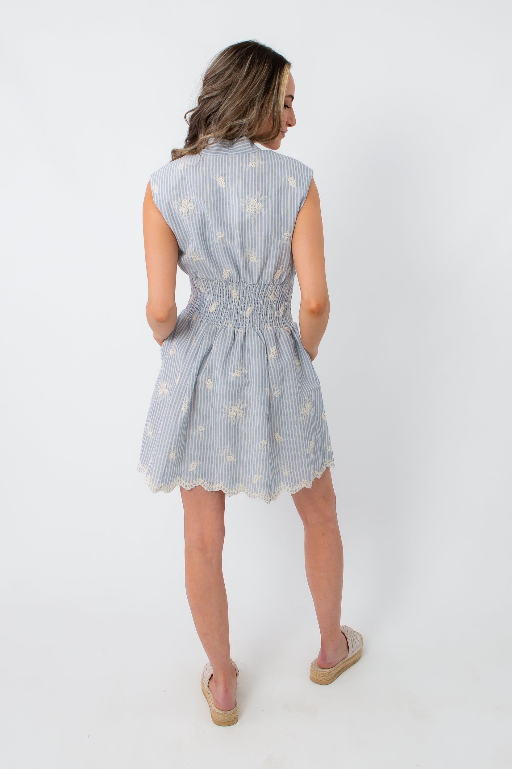 Blue and white embroidered mini dress with smocked waist and scalloped hem