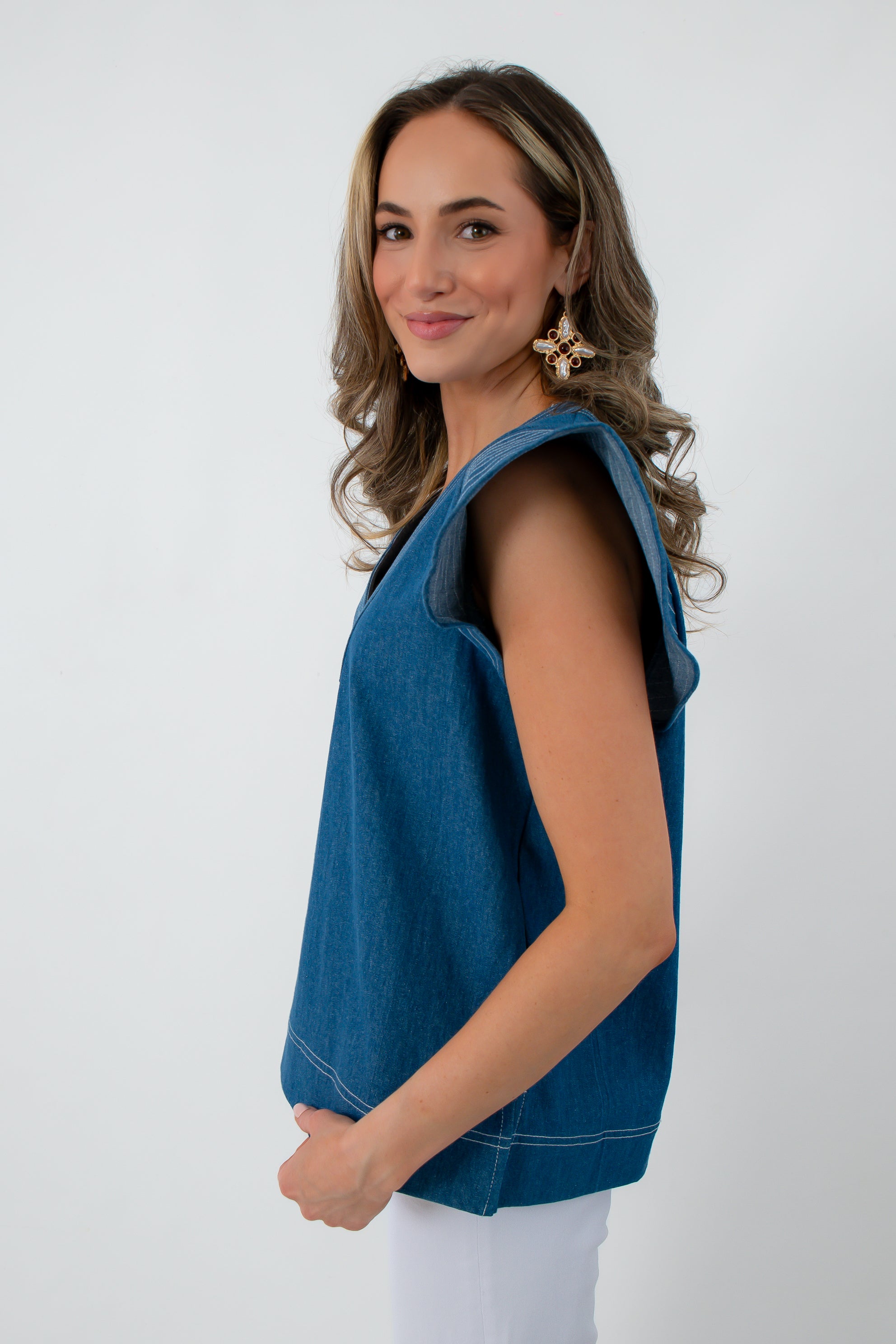 Side view of denim twill blue short sleeve blouse with contrast stitching, women's fashion top