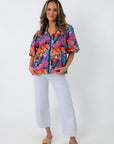 Vibrant floral blouse with puff sleeves and zip closure