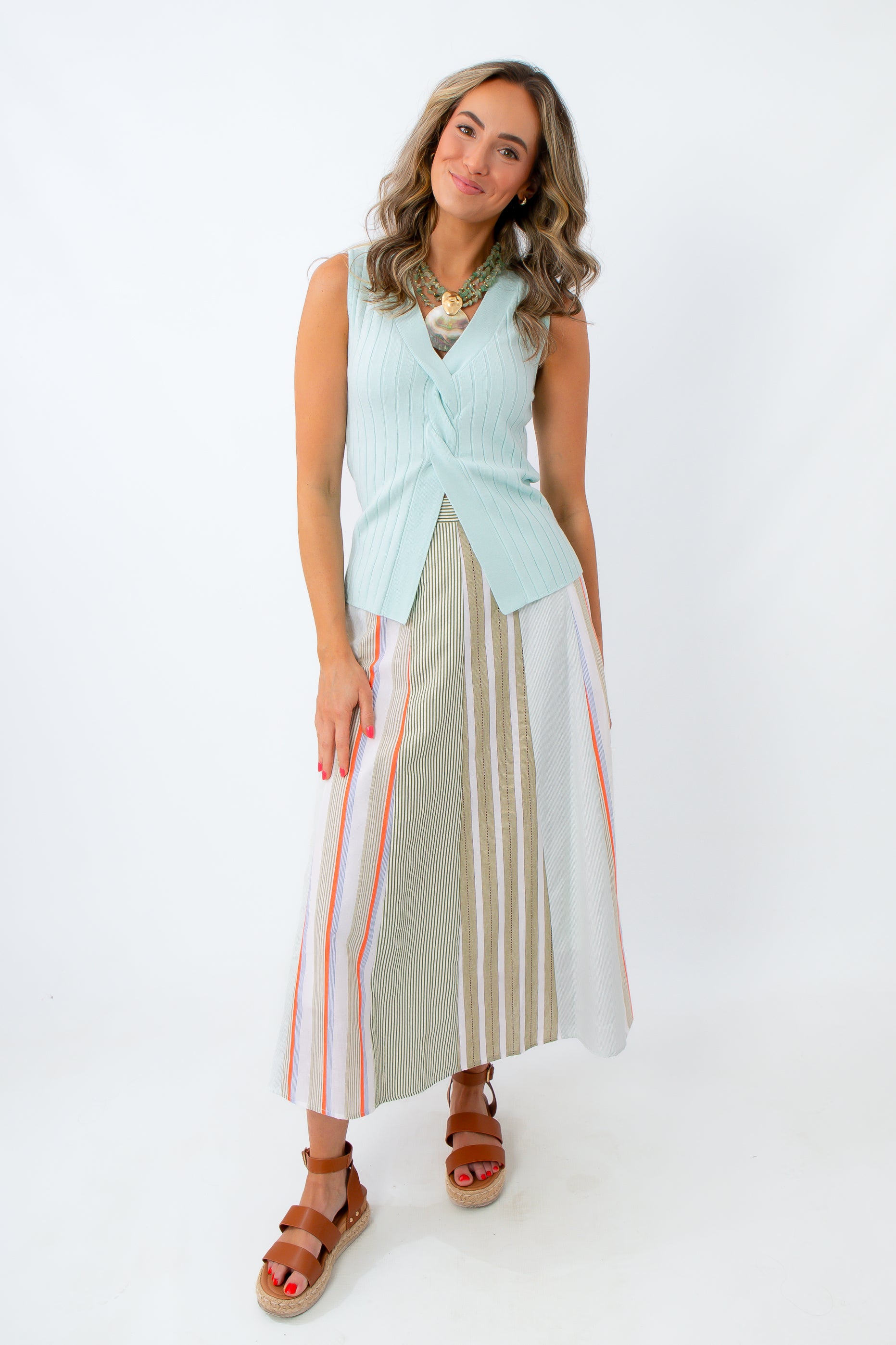 mint knit top styled with summer midi skirt and statement necklace