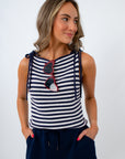 Woman wearing a navy and white striped sleeveless top with red sunglasses for a casual 4th of july outfit