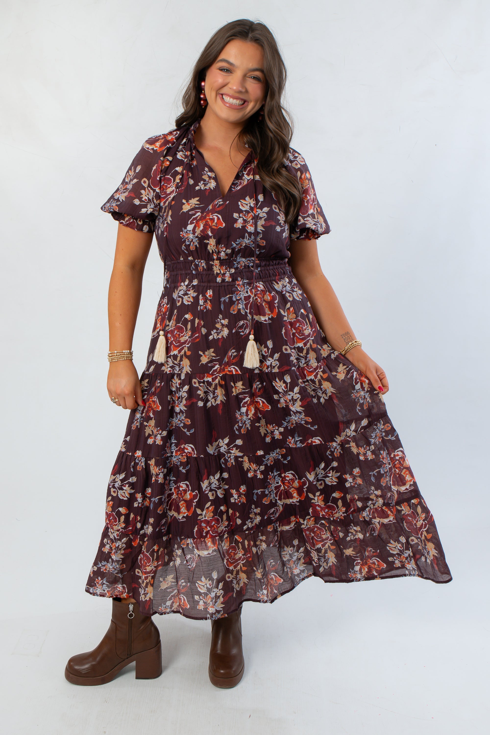 THML Burgundy Printed Puff Sleeve Tiered Maxi Dress with floral pattern and tassel tie neckline, styled for fall at L Mae Boutique.