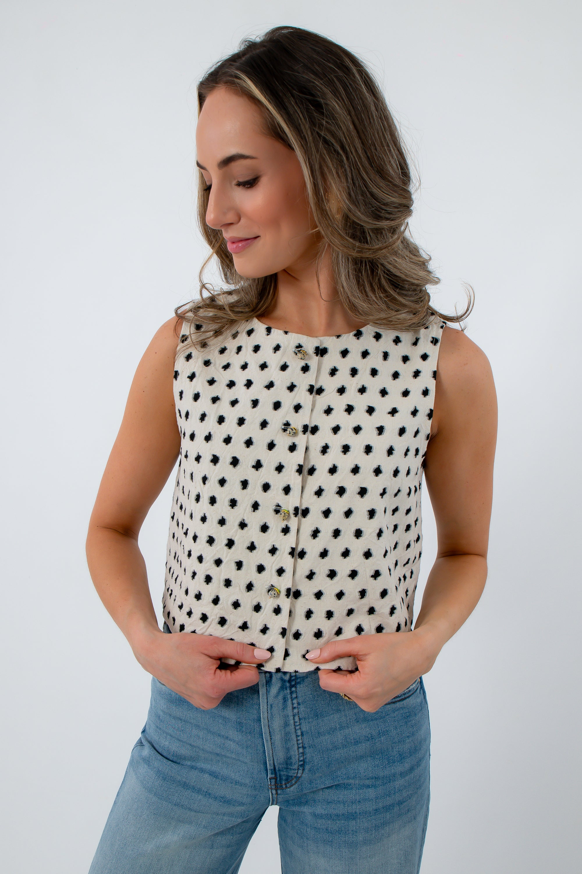 Cream sleeveless knit top with black polka dots for women
