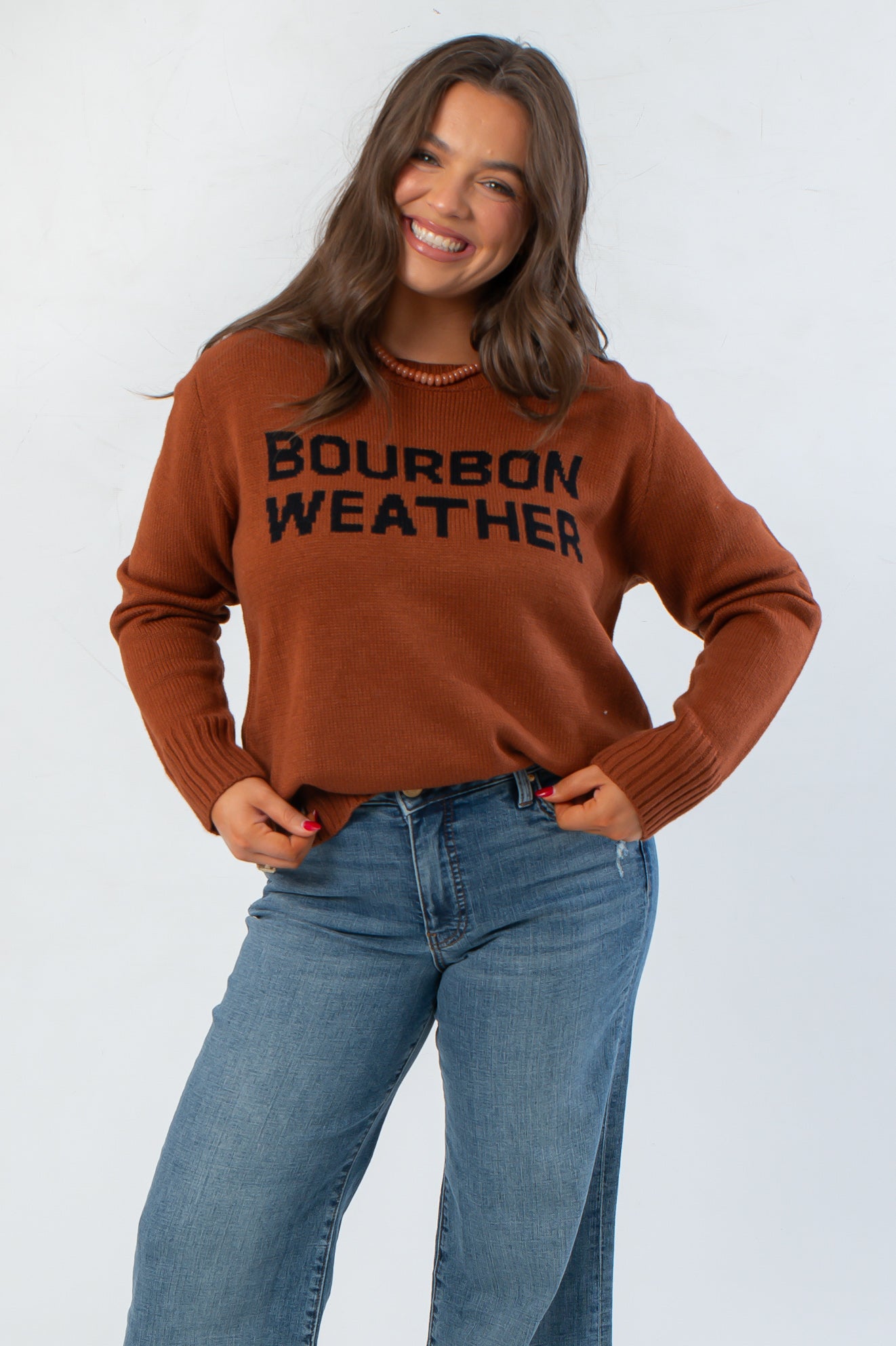 Bourbon Weather Intarsia Knit Sweater in warm brown with bold black lettering, perfect cozy top for fall and winter layering.
