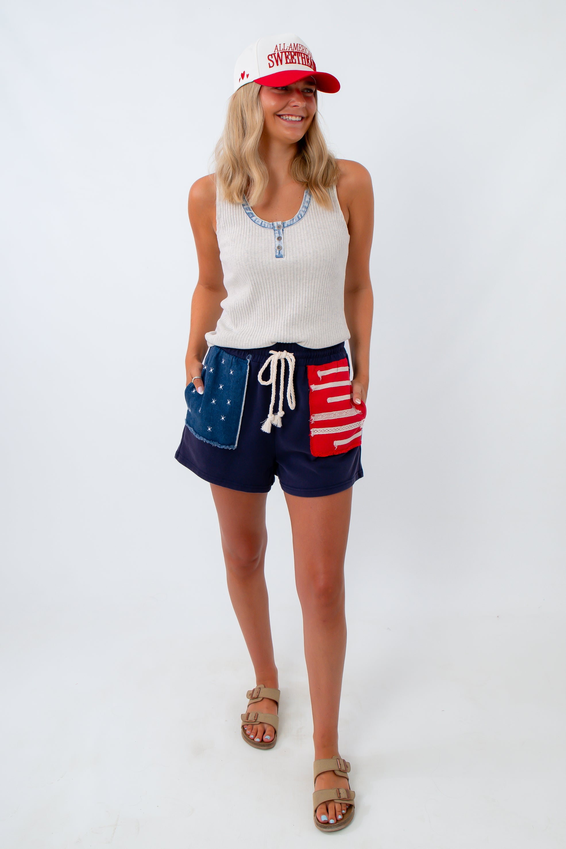 casual henley tank top for jeans and shorts styled with american flag shorts and trucker hat