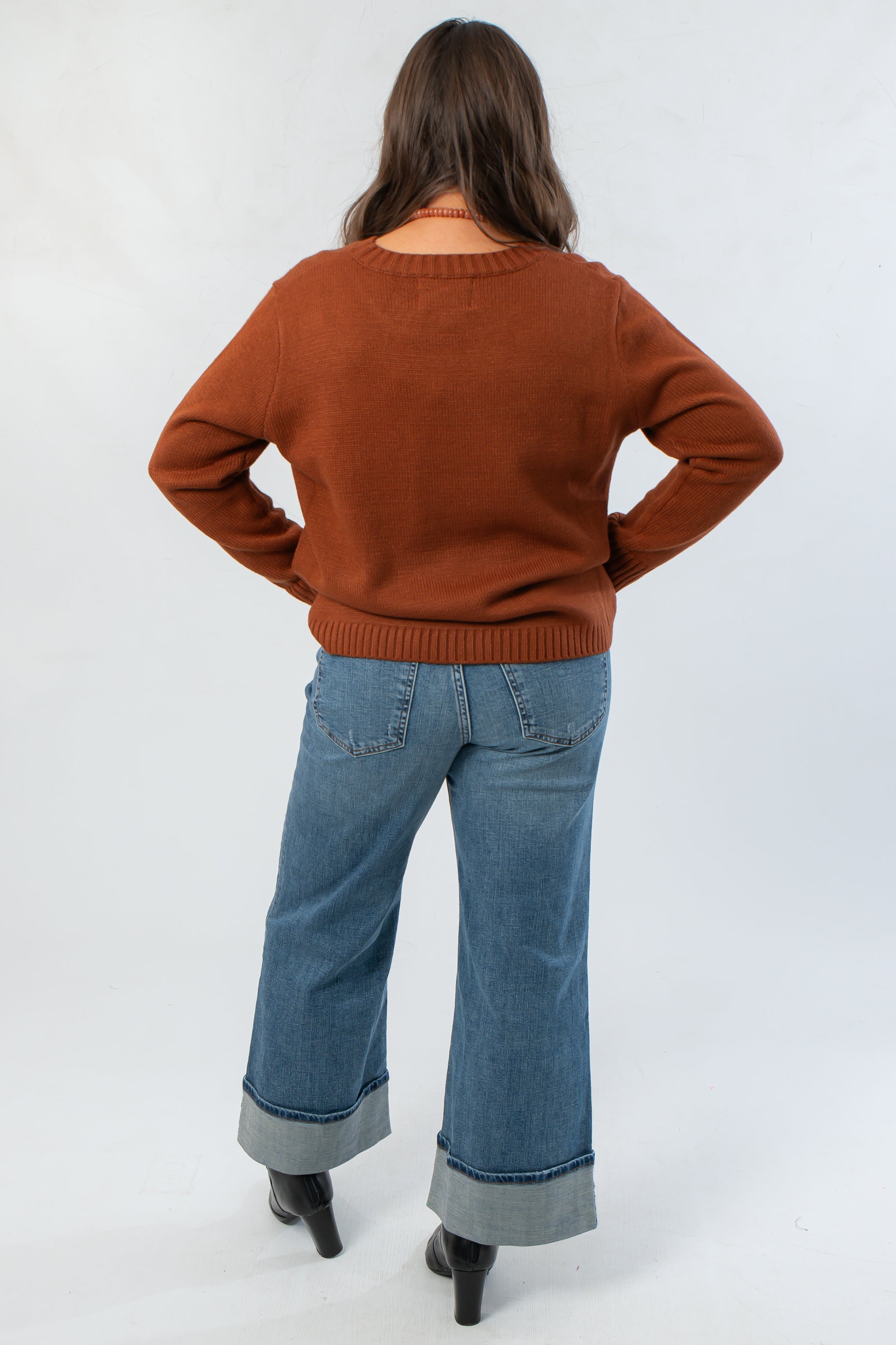 Back view of Bourbon Weather Intarsia Knit Sweater in rich bourbon color, highlighting soft knit texture and classic crew neckline.