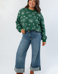 Hunter Green Pumpkin Pie Cutie Pullover Sweatshirt paired with cuffed jeans and boots, showcasing a relaxed fall fashion look.
