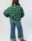 Back view of Pumpkin Pie Cutie Hunter Green Pullover Sweatshirt with whimsical autumn graphics, great for casual fall layering.