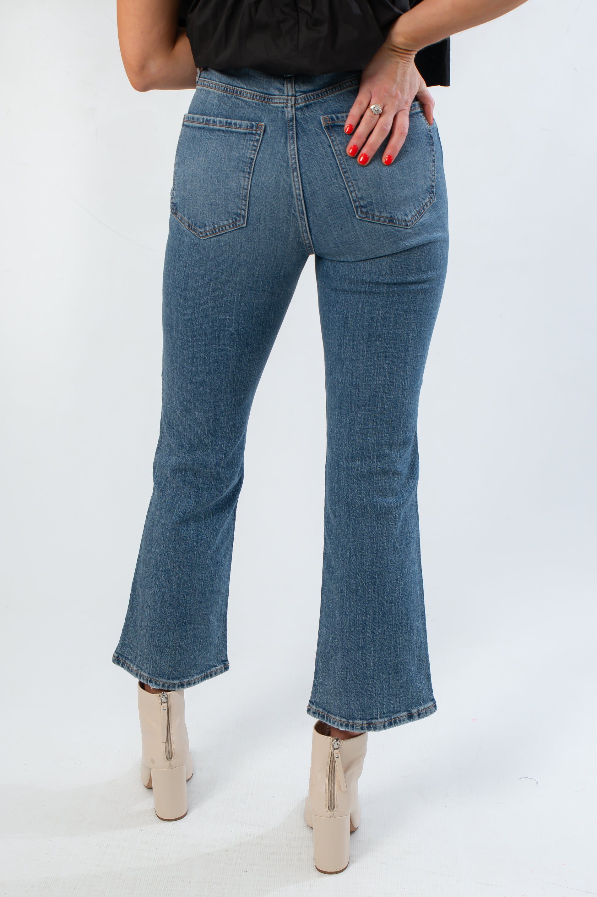 Back view of Daze Denim Rush Hour Soho High Rise Ankle Flare jeans highlighting rear pockets, high waist, and flared ankle fit.