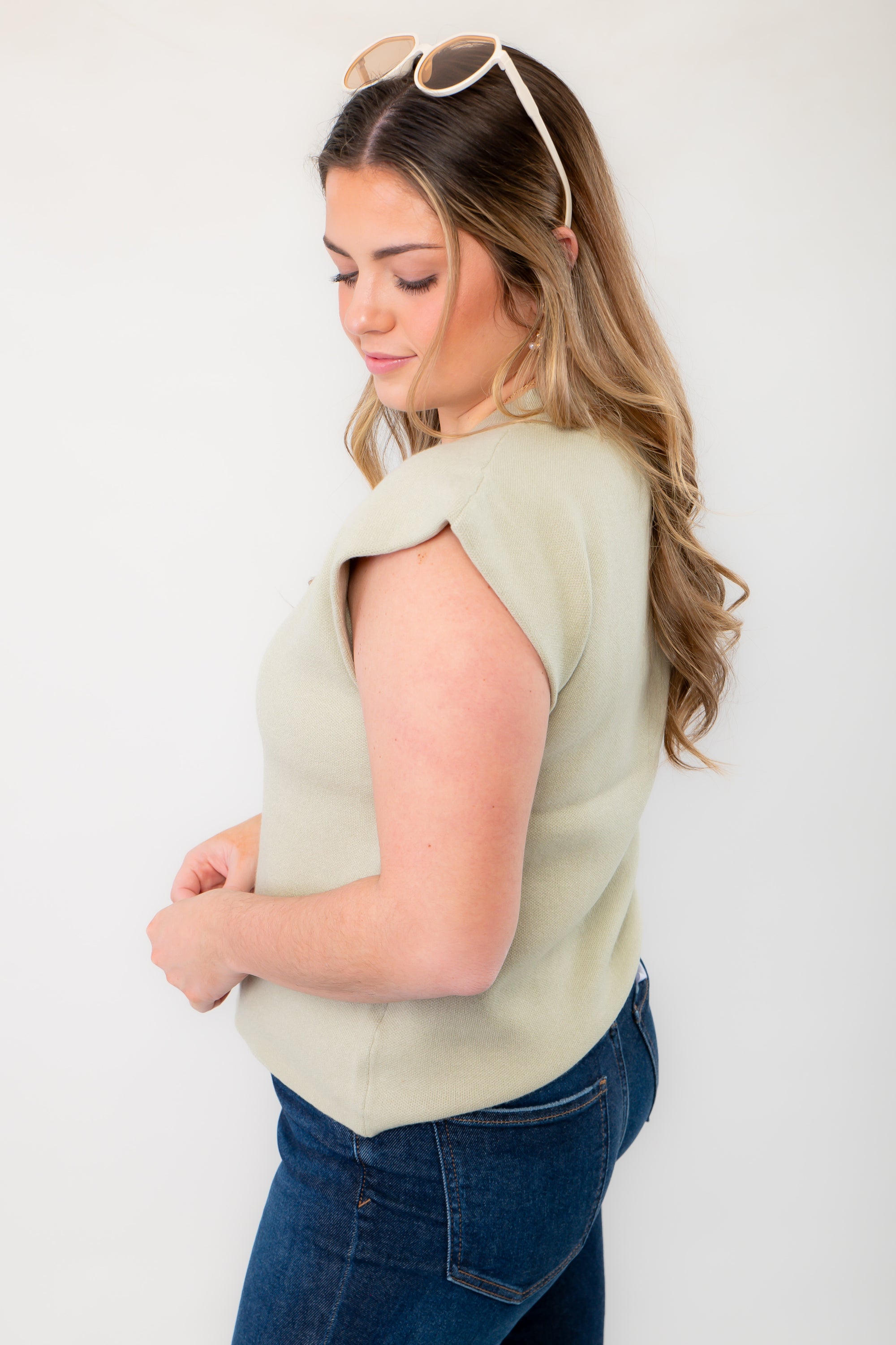 Side view of the Dally Sage Green Muscle Sweater Tank showcasing its structured cap sleeves and soft knit fabric.