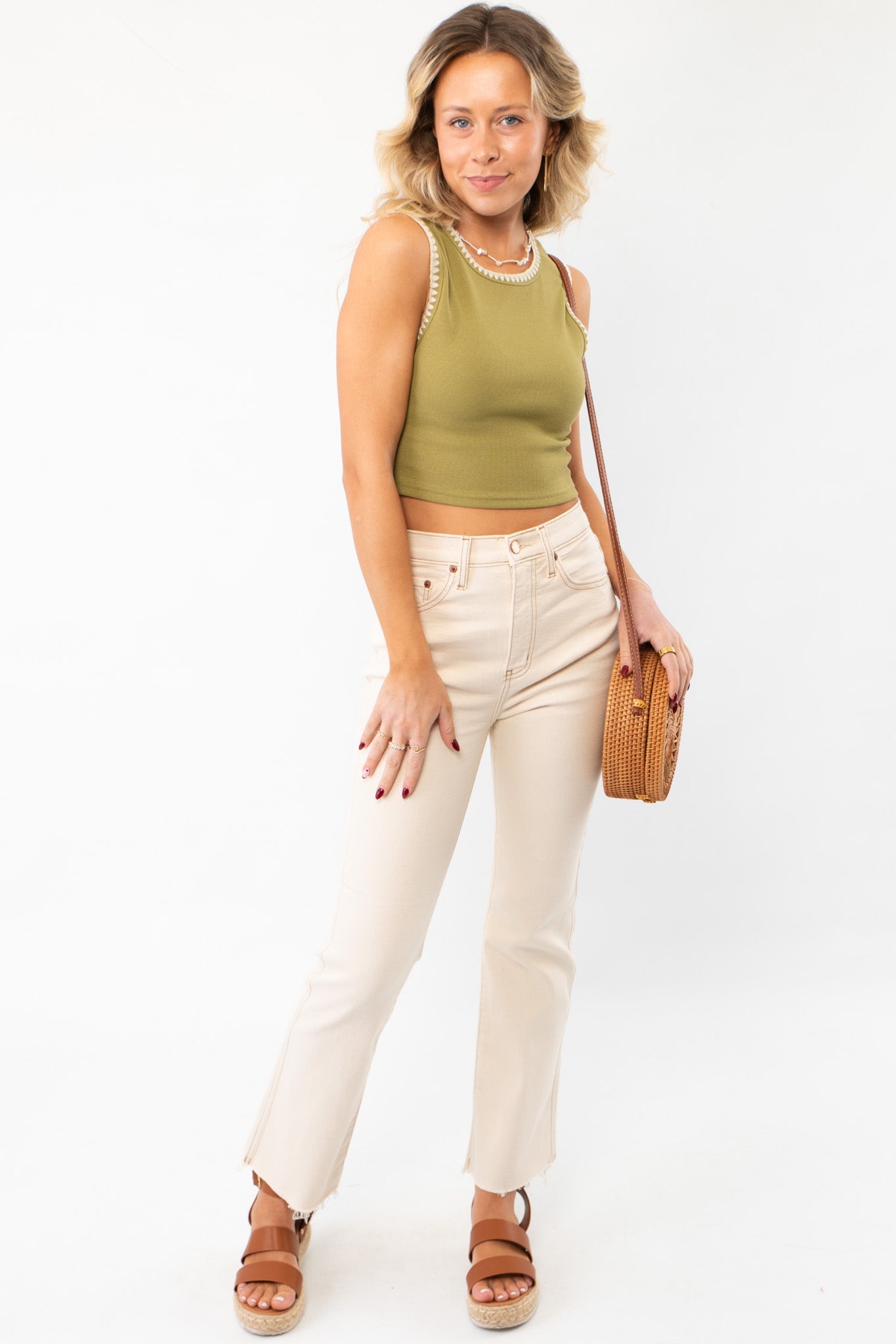 Effortlessly stylish Daze Oat Milk Soho Raw Cut High Rise Ankle Flare jeans paired with a cropped top and sandals, perfect for a trendy casual look.