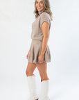 Side profile of Call Me Back Skirt Set-Dark Taupe Knit showing flattering fit and flowy pleated skirt. Stylish fall essential with boots.
