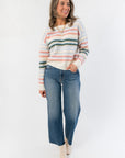 Cozy Mountain Top Stripe Knit Sweater in pastel pink, blue, and green stripes paired with wide-leg jeans and ankle boots for fall fashion.
