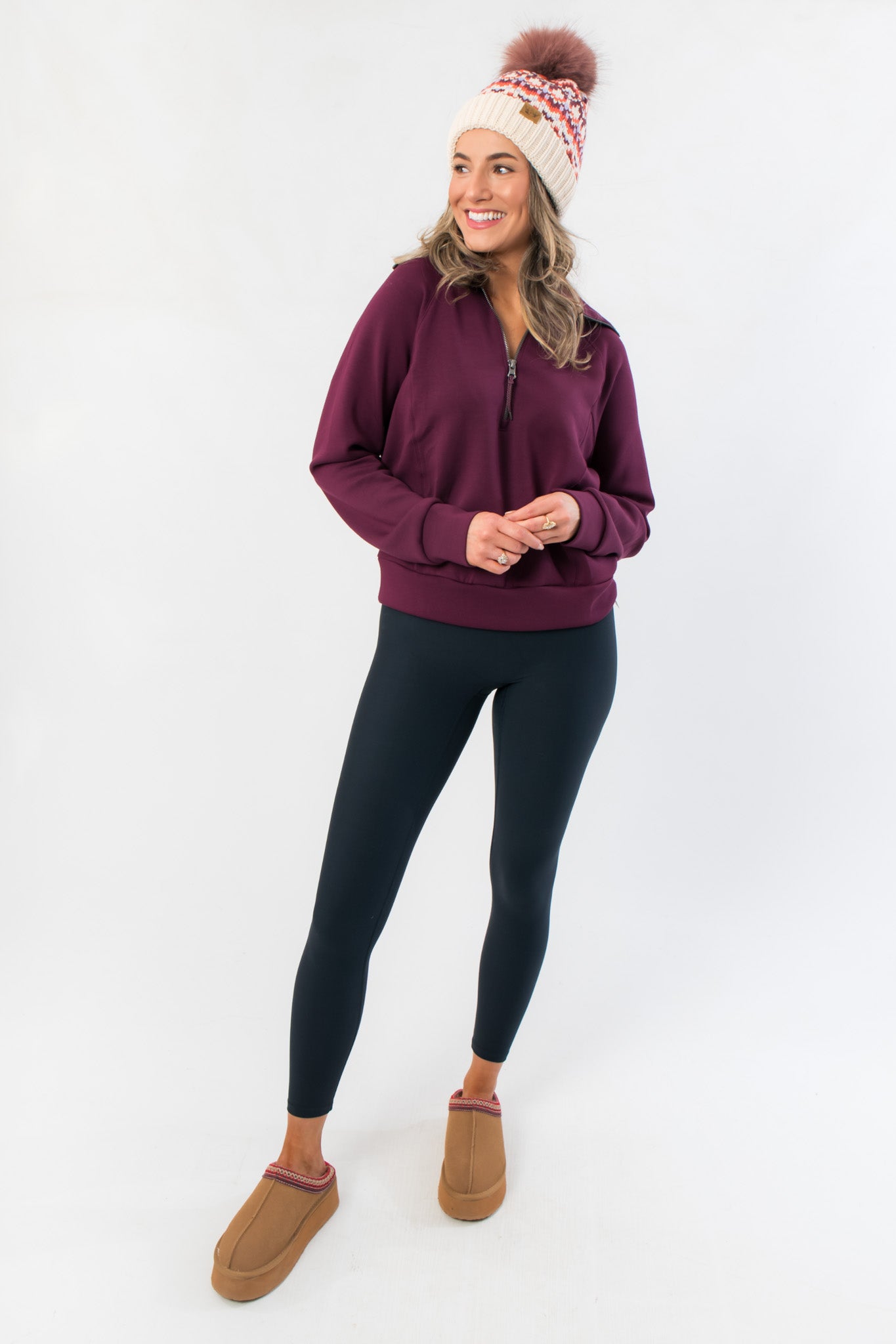 Full-body view of Spanx Plum Berry Air Essentials Half Zip Sweatshirt – Women’s Pullover, paired with leggings and cozy slippers.