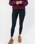 Close-up front view of Spanx Very Black Full Length Leggings showcasing sleek, slimming fit and ankle-length cut for women.