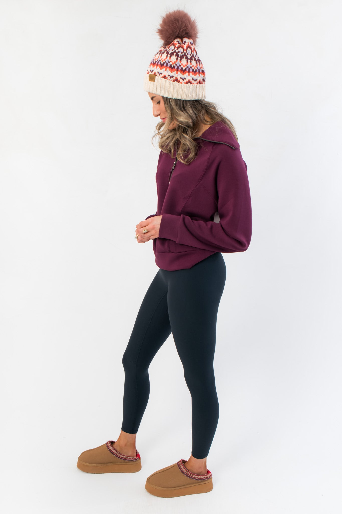 Side profile of Spanx Plum Berry Air Essentials Half Zip Sweatshirt showing relaxed fit and soft fabric, styled with casual loungewear.