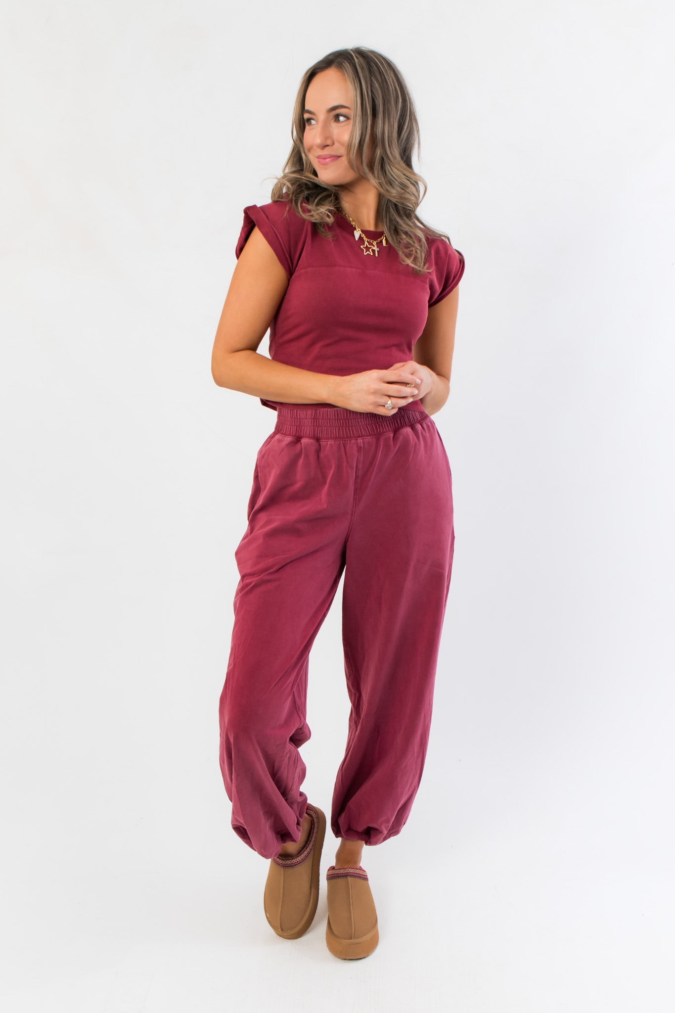 Winterberry Elastic Waist Jogger Sweatpants in berry red styled with matching crop top, featuring relaxed fit and ankle cuffs for cozy loungewear.