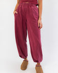 Close-up of Winterberry Elastic Waist Jogger Sweatpants showing elastic waistband, side pockets, and soft berry red fabric for casual comfort.