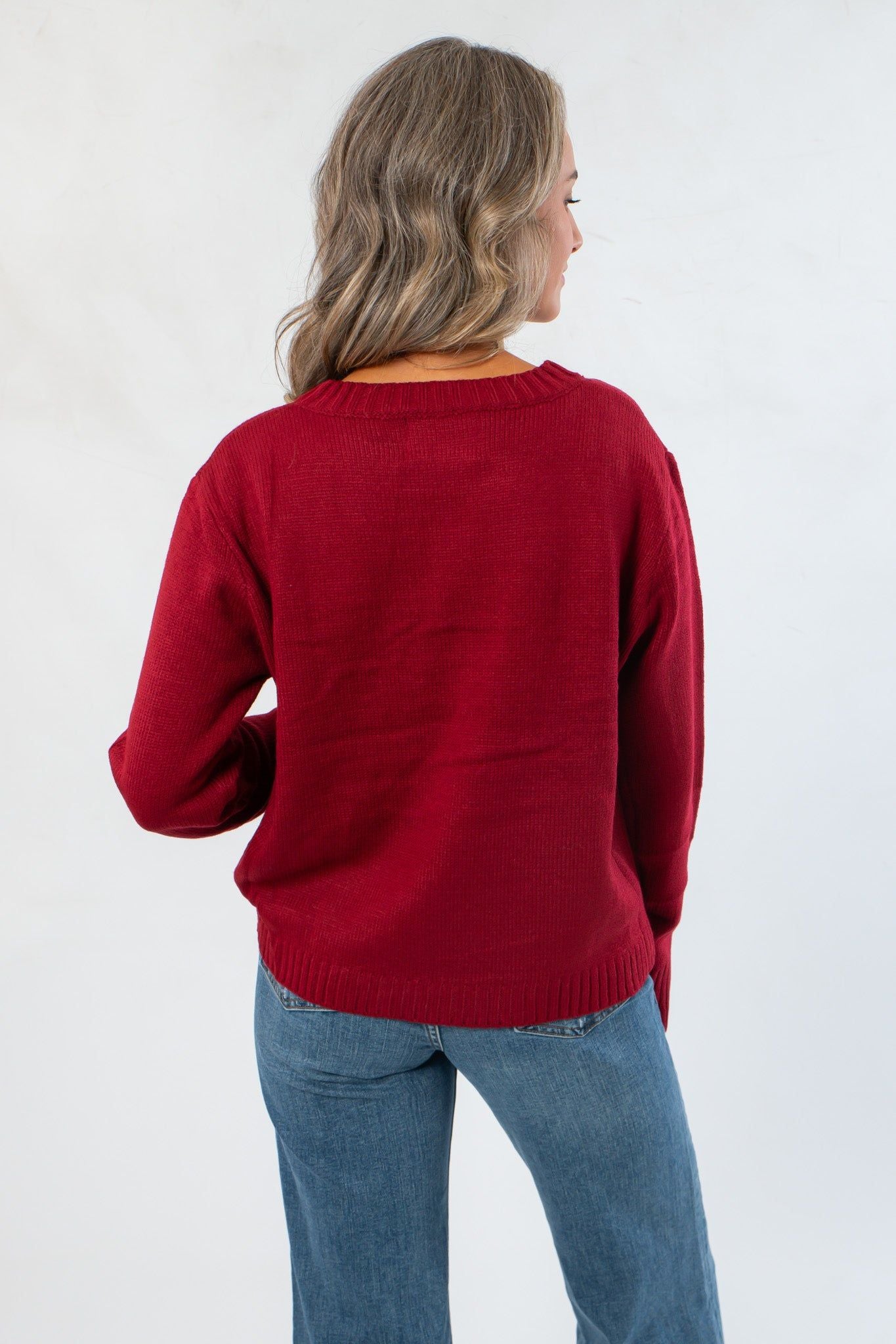 Back view of Game Day Garnet Knit Sweater showcasing solid maroon knit and ribbed detailing on hem and cuffs.