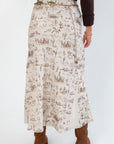 Detailed rear view of Old West Satin Maxi Skirt – Cream Satin with Western Icons, highlighting the flowing silhouette and intricate western motifs.