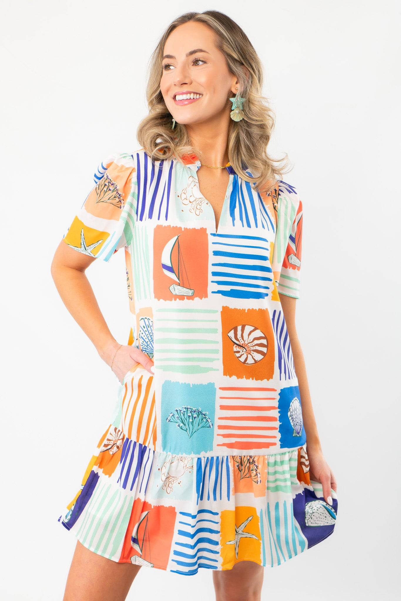 Front view of THML At Sea Nautical Printed Dress with playful ocean motifs, v-neckline, and flutter sleeves perfect for vacation wear.