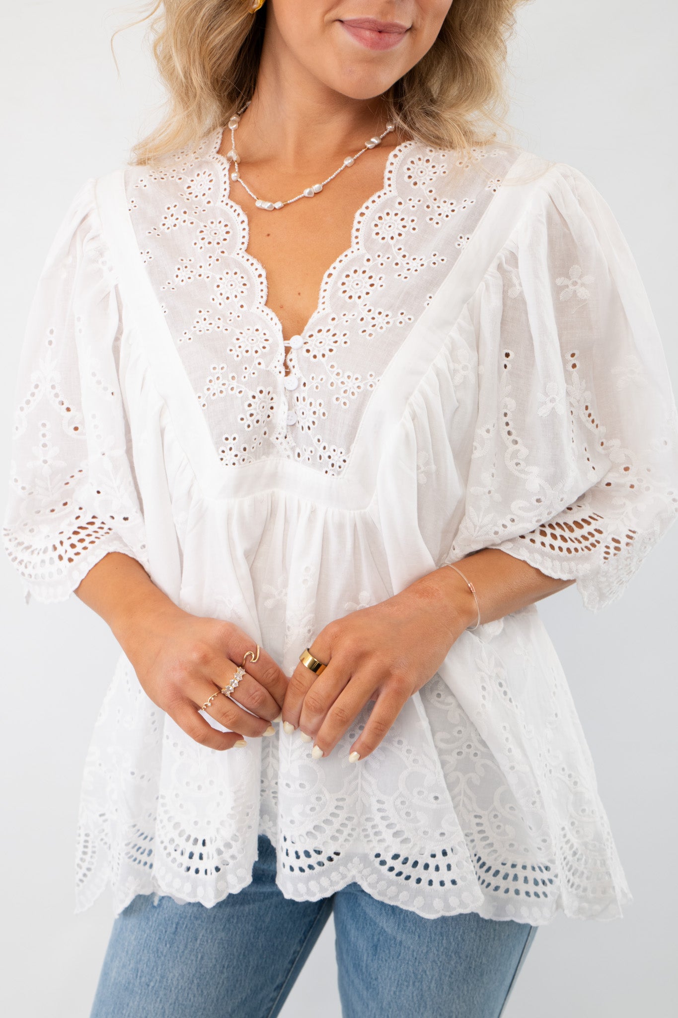 FA Off White Short Sleeve Eyelet Top WM featuring delicate lace details, scalloped edges, and a flowy silhouette. Perfect for summer styling.