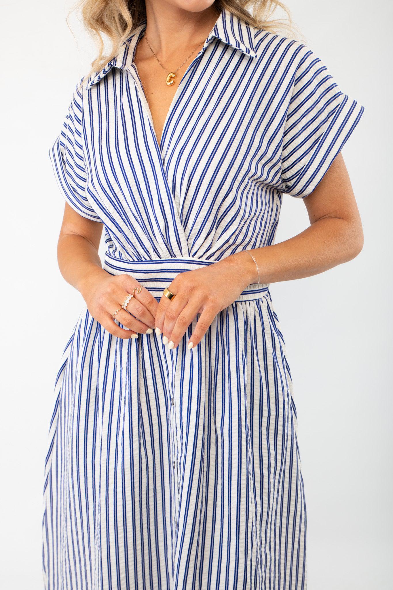 Close-up of the Favorite Things Blue Striped Midi Dress, highlighting the flattering wrap-style waist, collared neckline, and elegant button details.