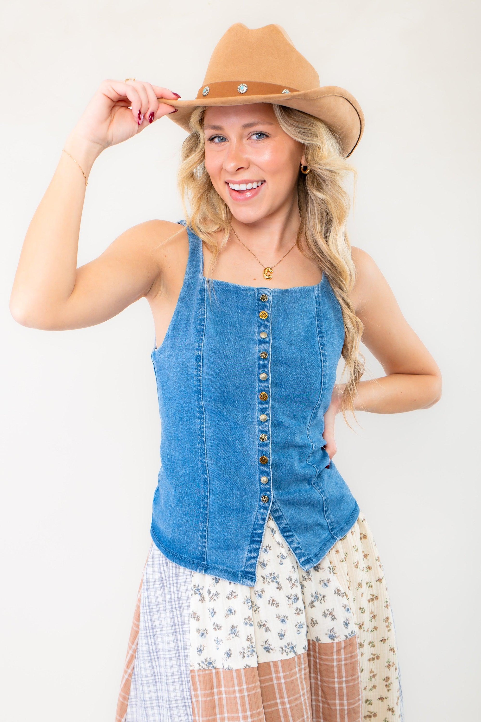 Country-inspired outfit featuring the Free People A Moment In Time Denim Vest paired with a patchwork skirt and a cowboy hat.