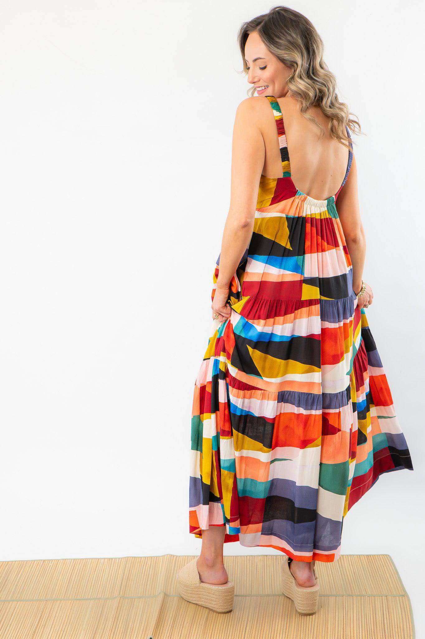 Back view of a colorful maxi dress with a low scoop design. A must-have for a girls' trip, offering comfort and effortless style.