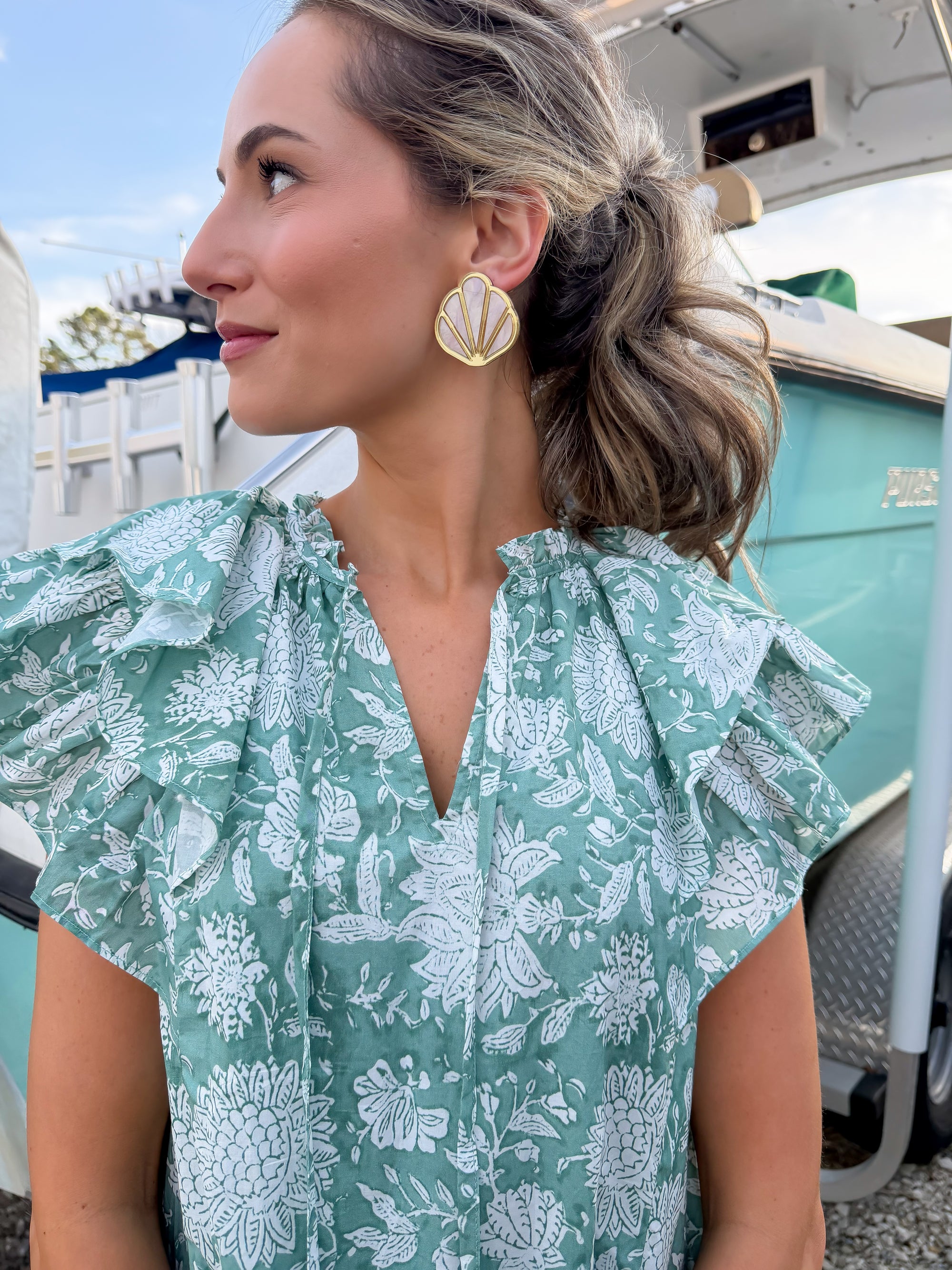 Woman wearing a green floral dress with a blurred background