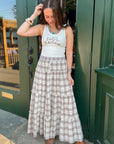 Fort Worth Brown Plaid Maxi Skirt styled with a white tank top and western boots, perfect for casual fall fashion.