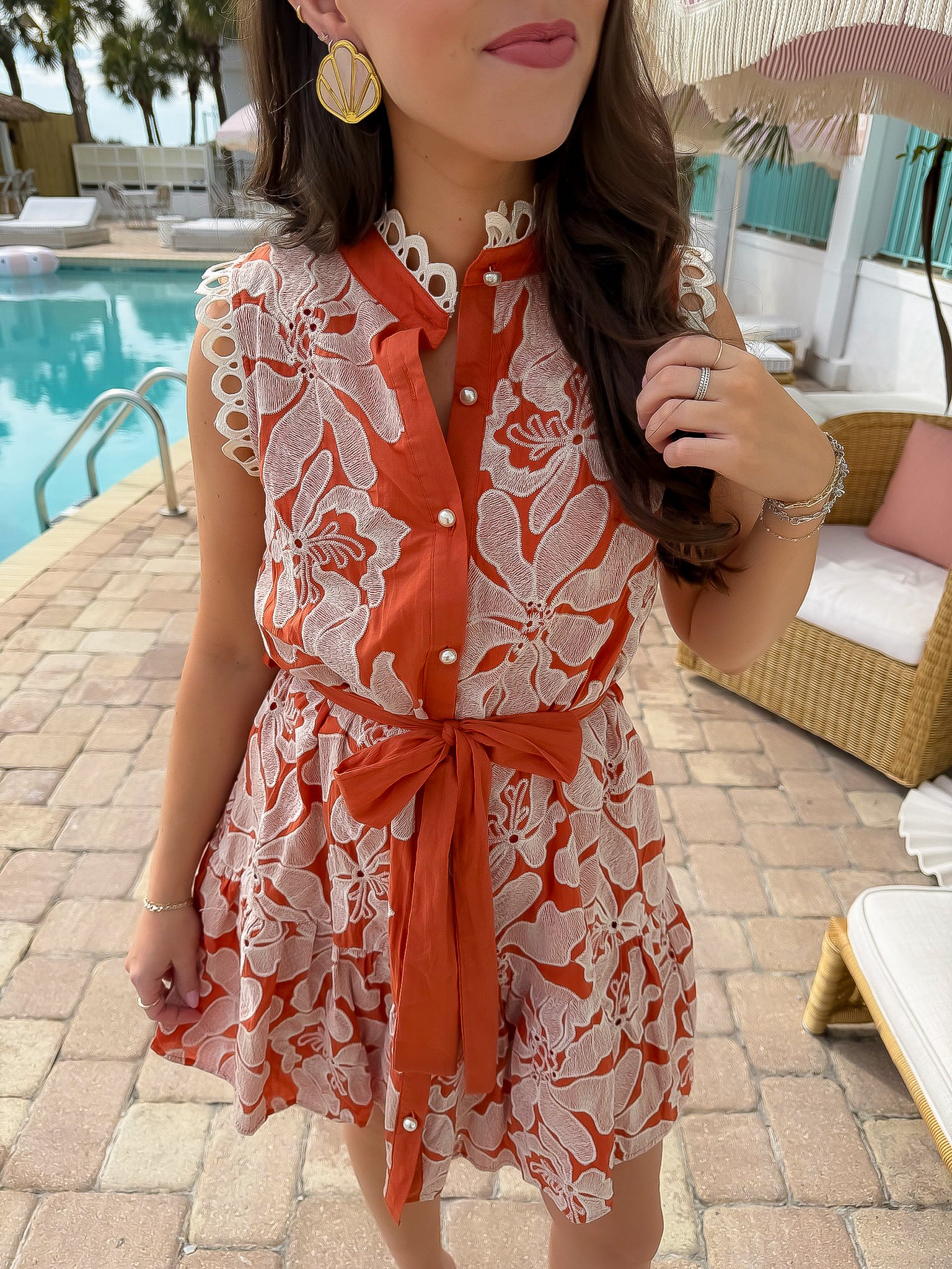 Close-up of Paloma Please Scallop Appliqué Sleeveless Dress showing floral appliqué, scalloped neckline, and belted waist in rust orange.