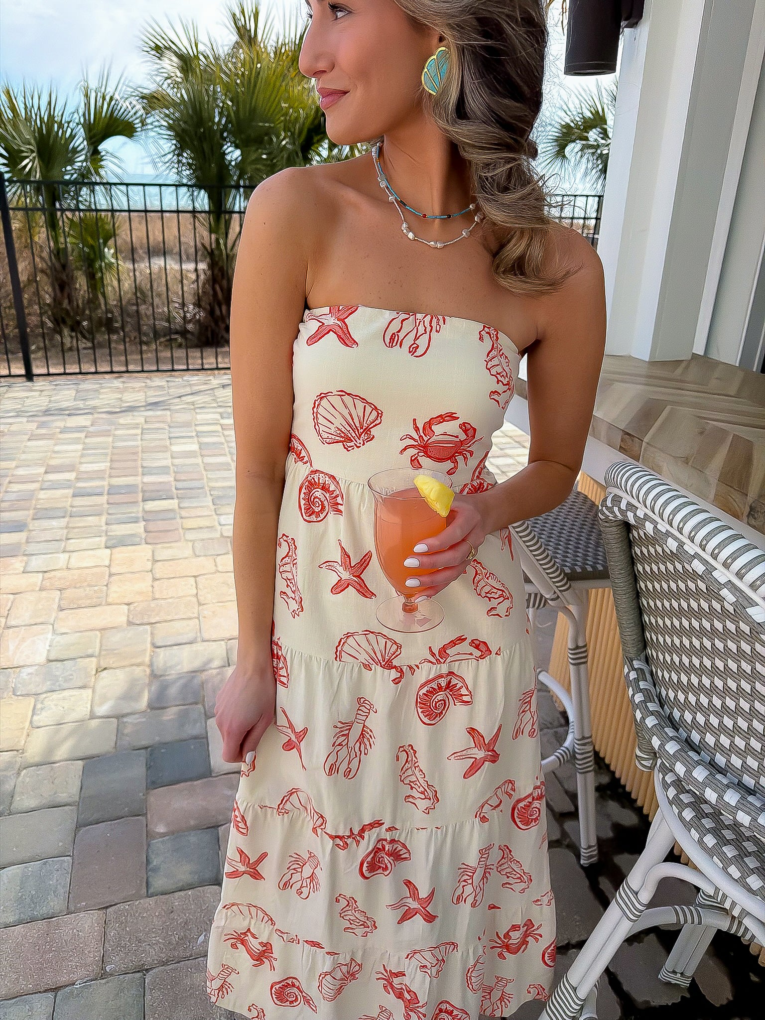 Shelby Red Seashell Printed Strapless Dress styled for a beachside brunch with coastal-chic shell motifs and a breezy midi silhouette.