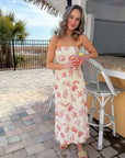 Coastal-chic Shelby Red Seashell Printed Strapless Dress worn at a tropical bar, featuring red shell prints and a relaxed midi fit.