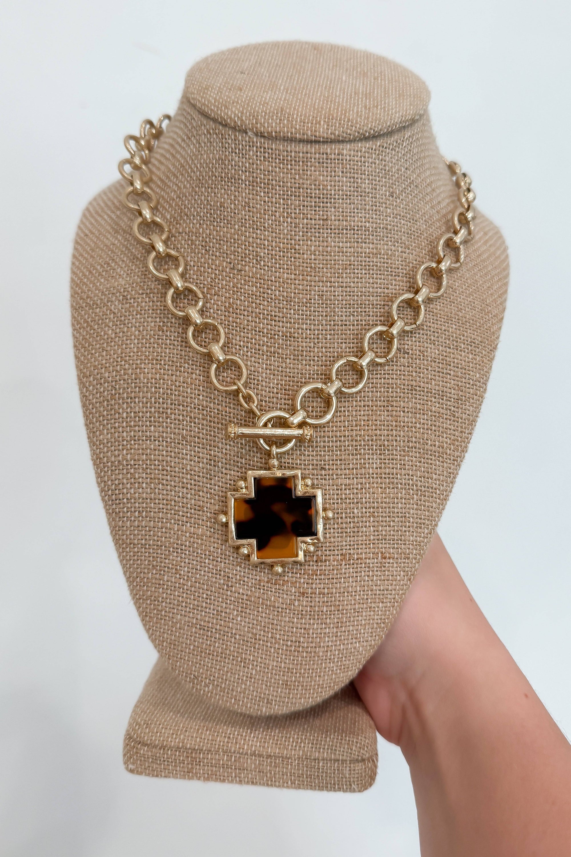 Tort Cross Pendant Necklace - Stylish & Elegant Jewelry featuring a bold tortoiseshell cross on a chunky gold chain. Ideal for fall fashion or gifting.