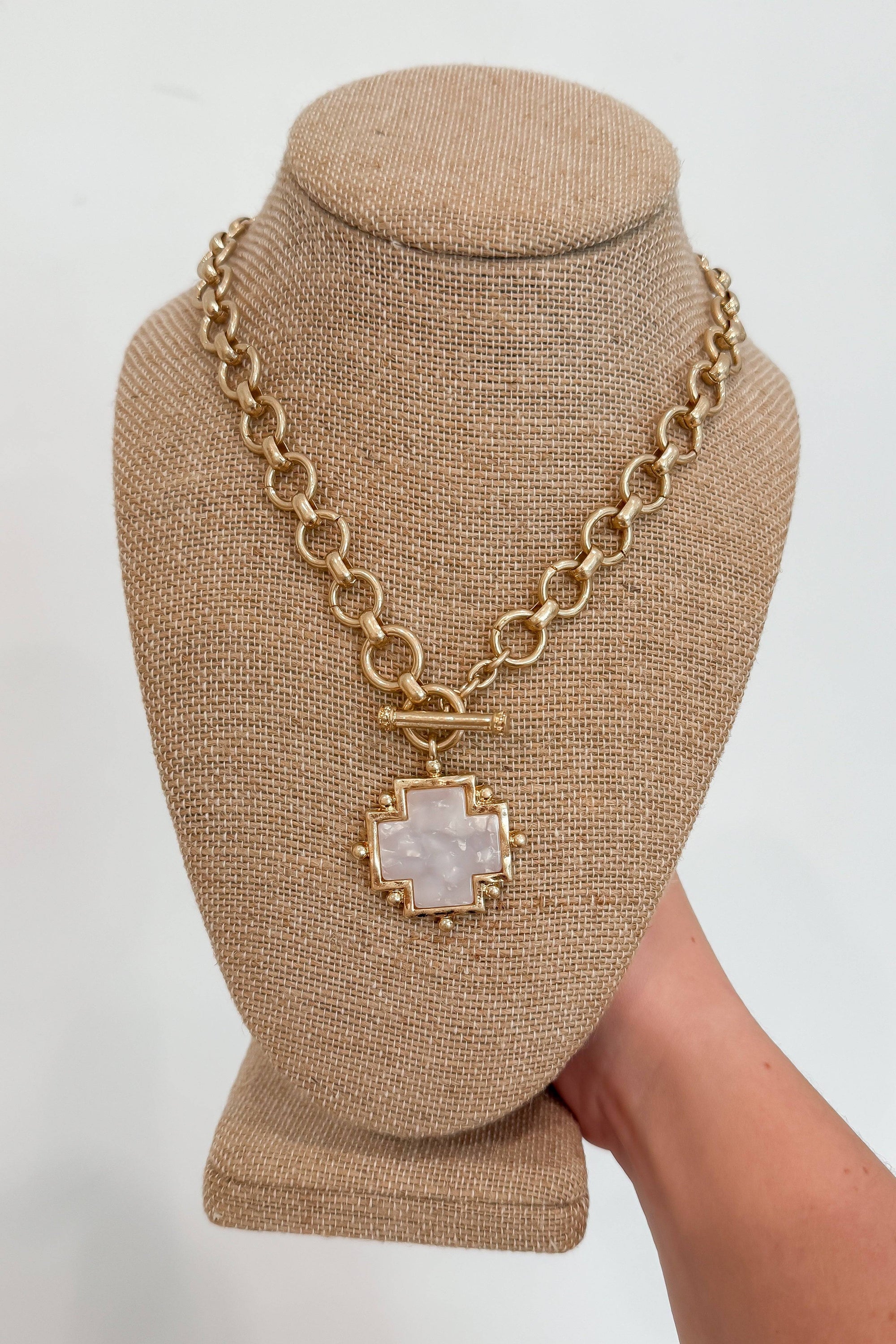 Cross Pendant Necklace featuring a pearl inlay on a chunky gold chain. Classic design ideal for elegant fall accessories or gift jewelry.
