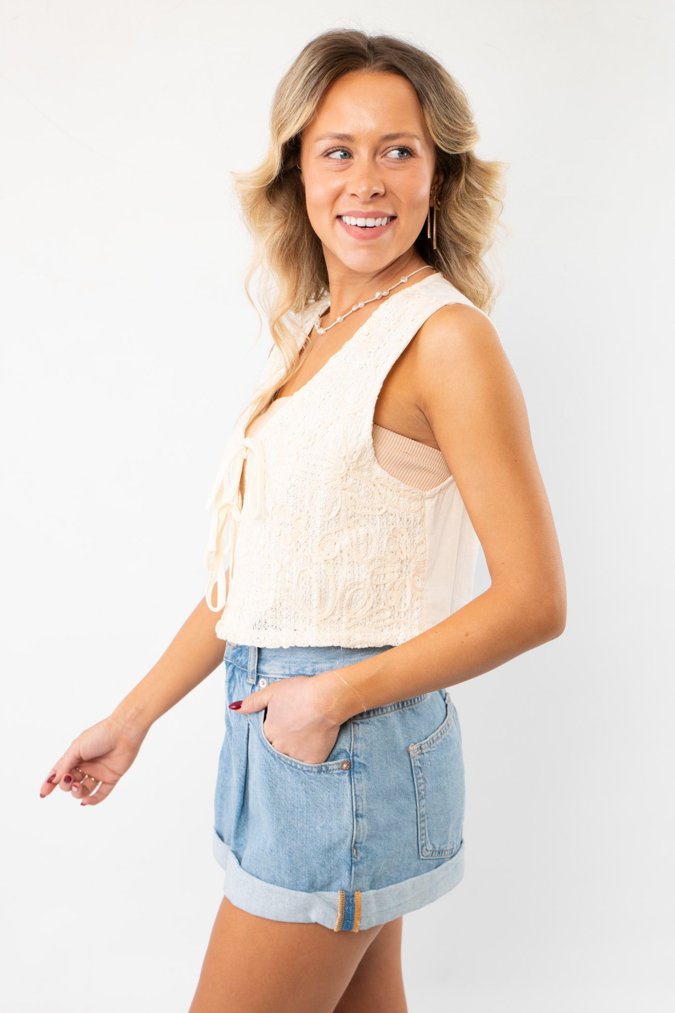 Side profile of the Jolene Beige Embroidered Tie Top Vest, highlighting its sleeveless design and lightweight fabric for an airy, summer-ready feel.