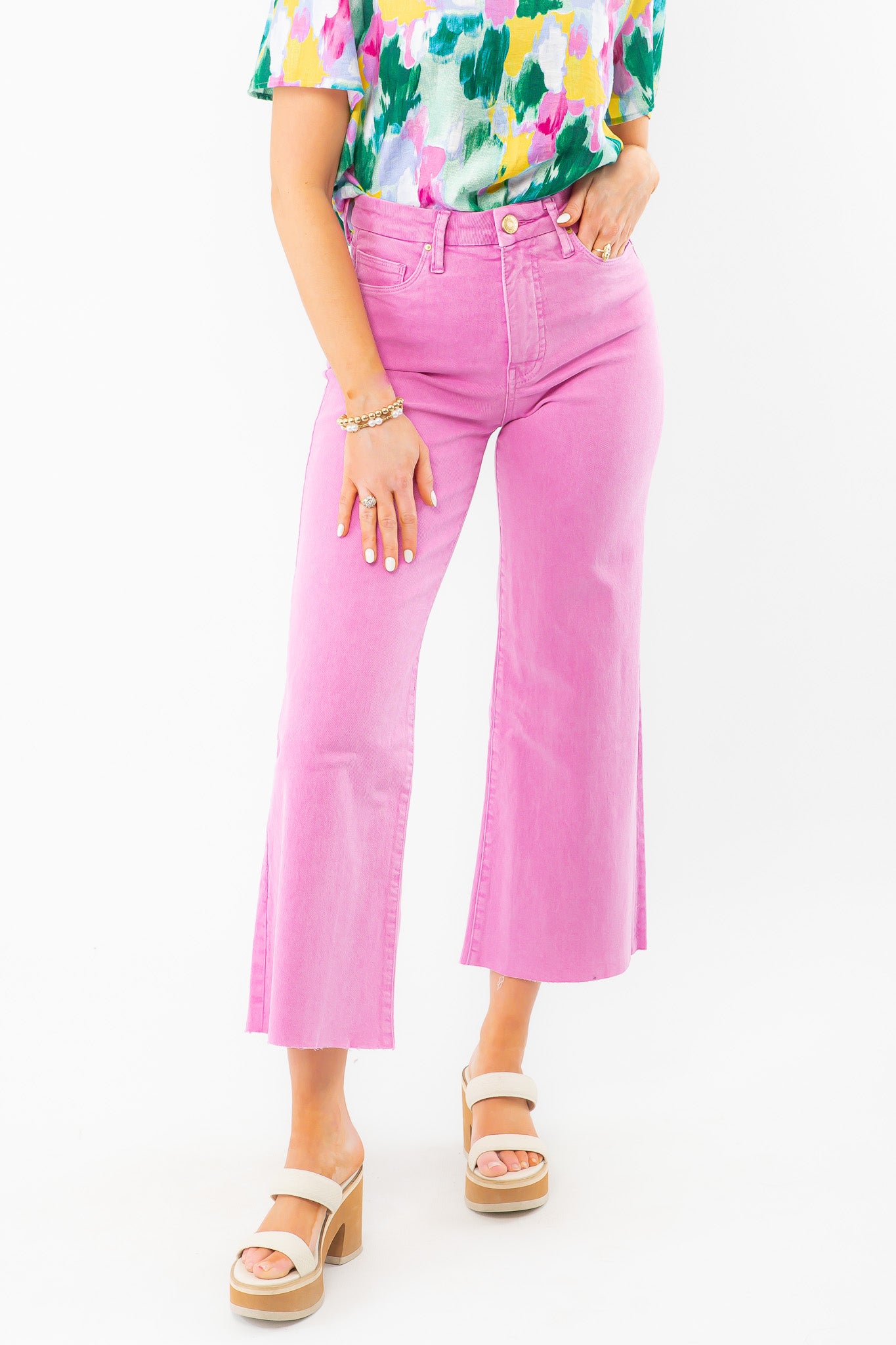 KUT Peony Pink Meg High Rise Wide Leg Jeans with raw hem and Fab Ab pockets, styled with a colorful blouse and platform sandals. Perfect for spring outfits.