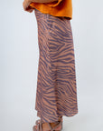 Elegant tiger print skirt with discreet zipper for game day style, purple and beige midi skirt for fall