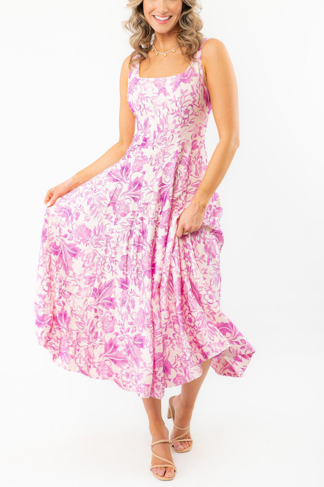 Layton Blush Tropical Print Midi Dress in a pink floral pattern, showcasing its breezy, flowy skirt. Ideal for summer days and tropical getaways.